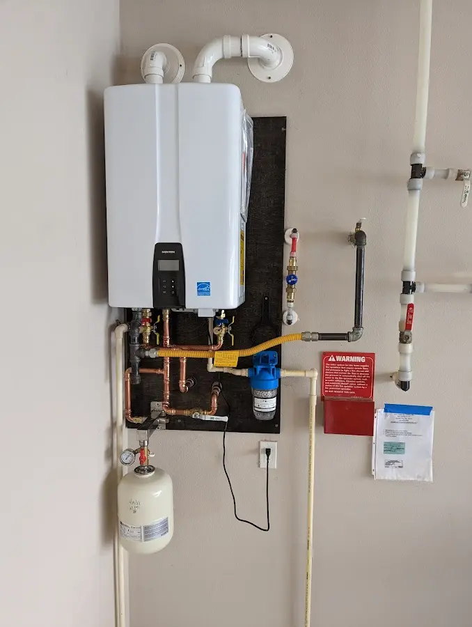 Professional plumber installing copper piping in a Maple Valley home